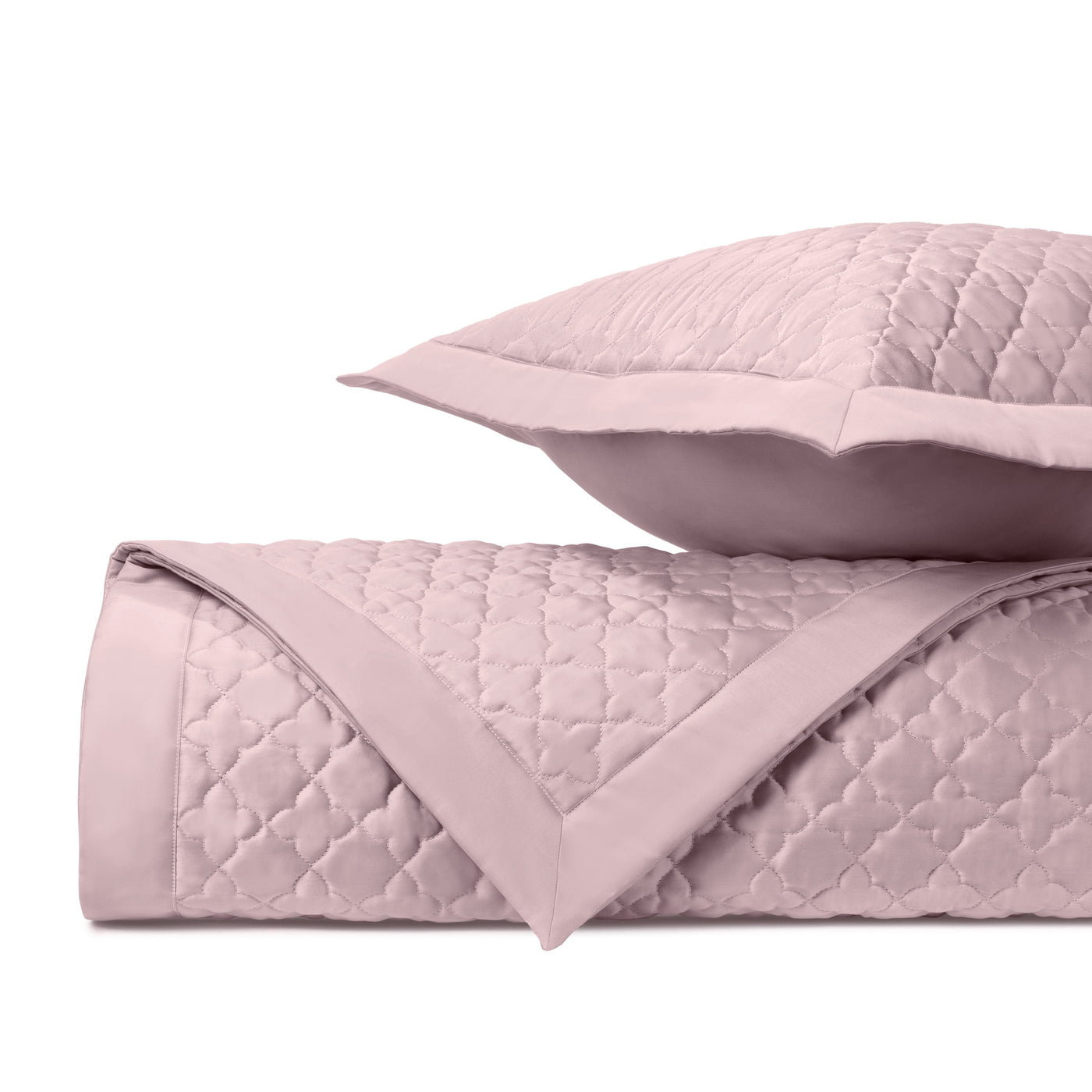 Close-up of Home Treasures Clover quilted texture in blush pink with trellis stitching.