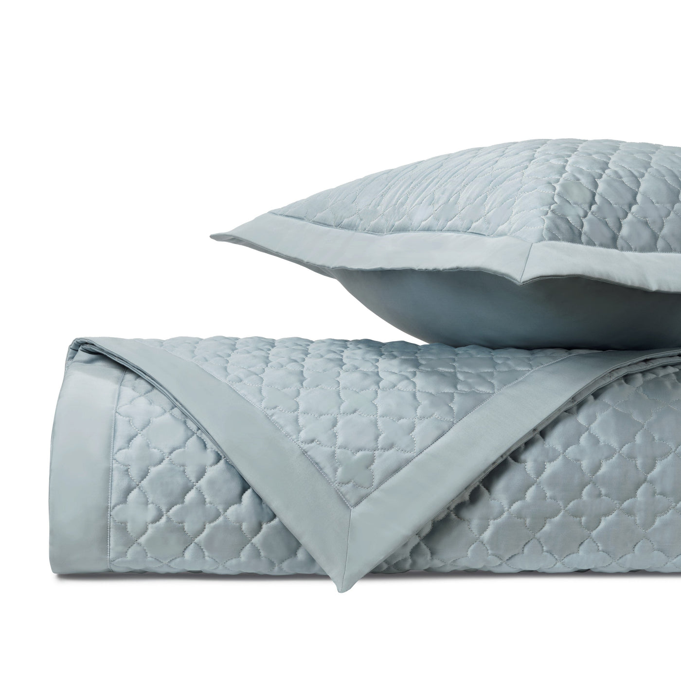 Close-up of Home Treasures Clover quilted satin in mist blue with trellis stitching.