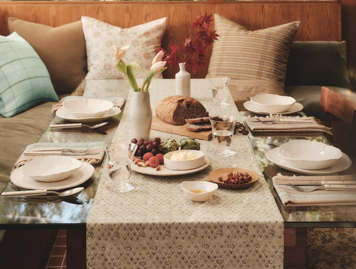Coyuchi Coral Bell Print table runner styled on a set dining table with linen placemats.