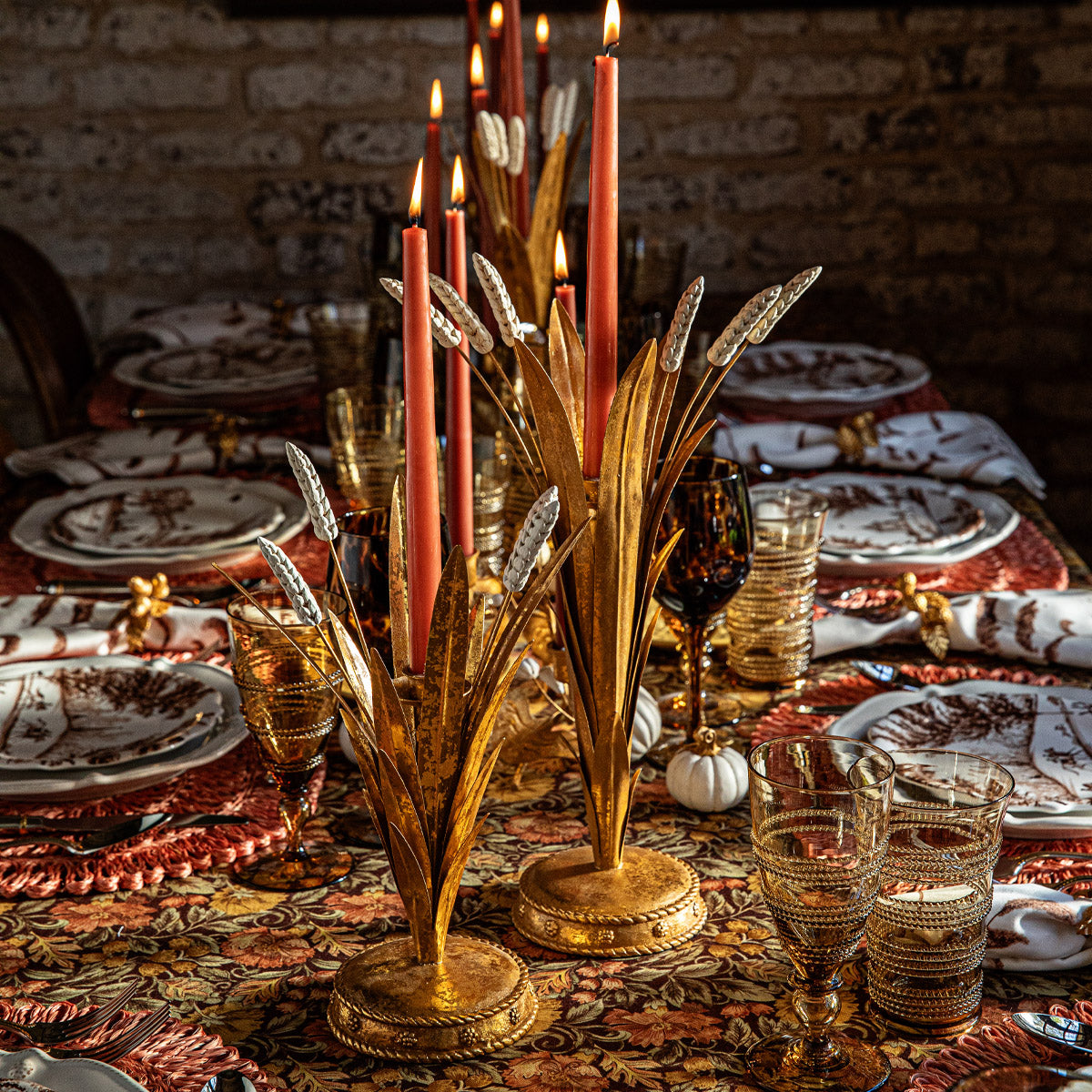 Forest Walk gold wheat candlestick holders with red tapers on an autumn table with patterned dishes