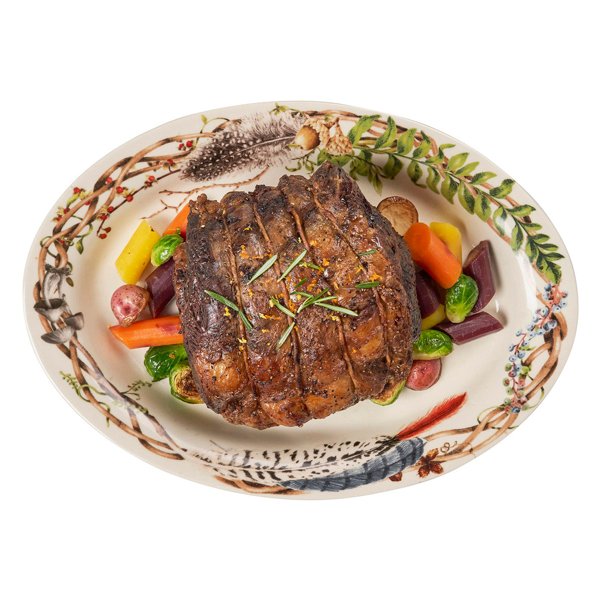 Juliska Forest Walk 17 inch oval platter with twig and feather rim, holding a roast with carrots and potatoes
