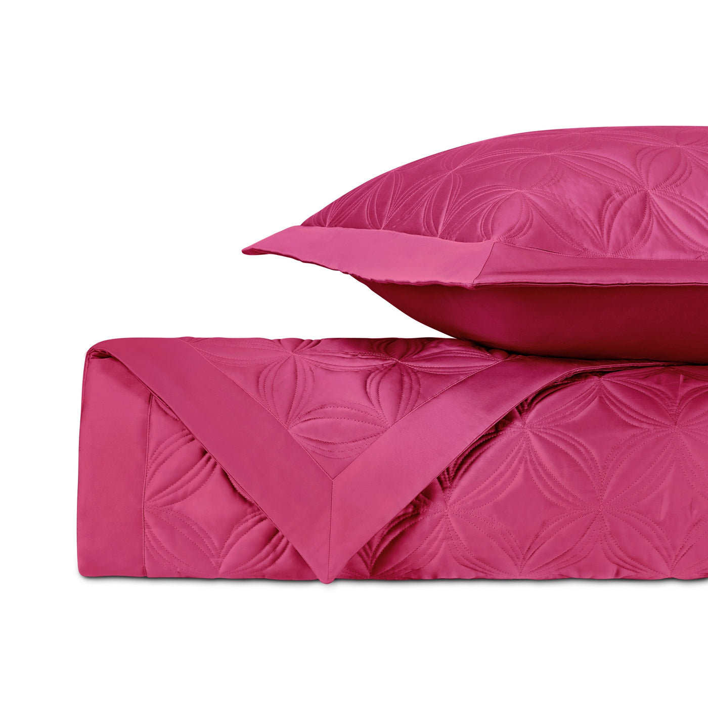 Folded fuchsia quilted coverlet with matching euro sham, floral medallion pattern.