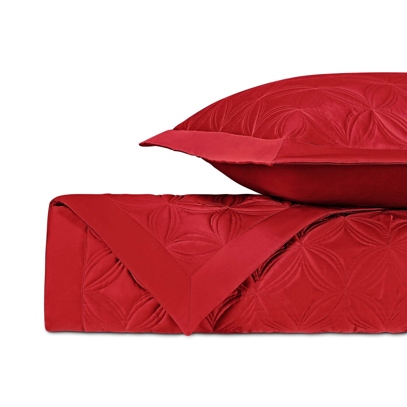 Crimson quilted coverlet and euro sham folded, showing embroidered floral medallion pattern.