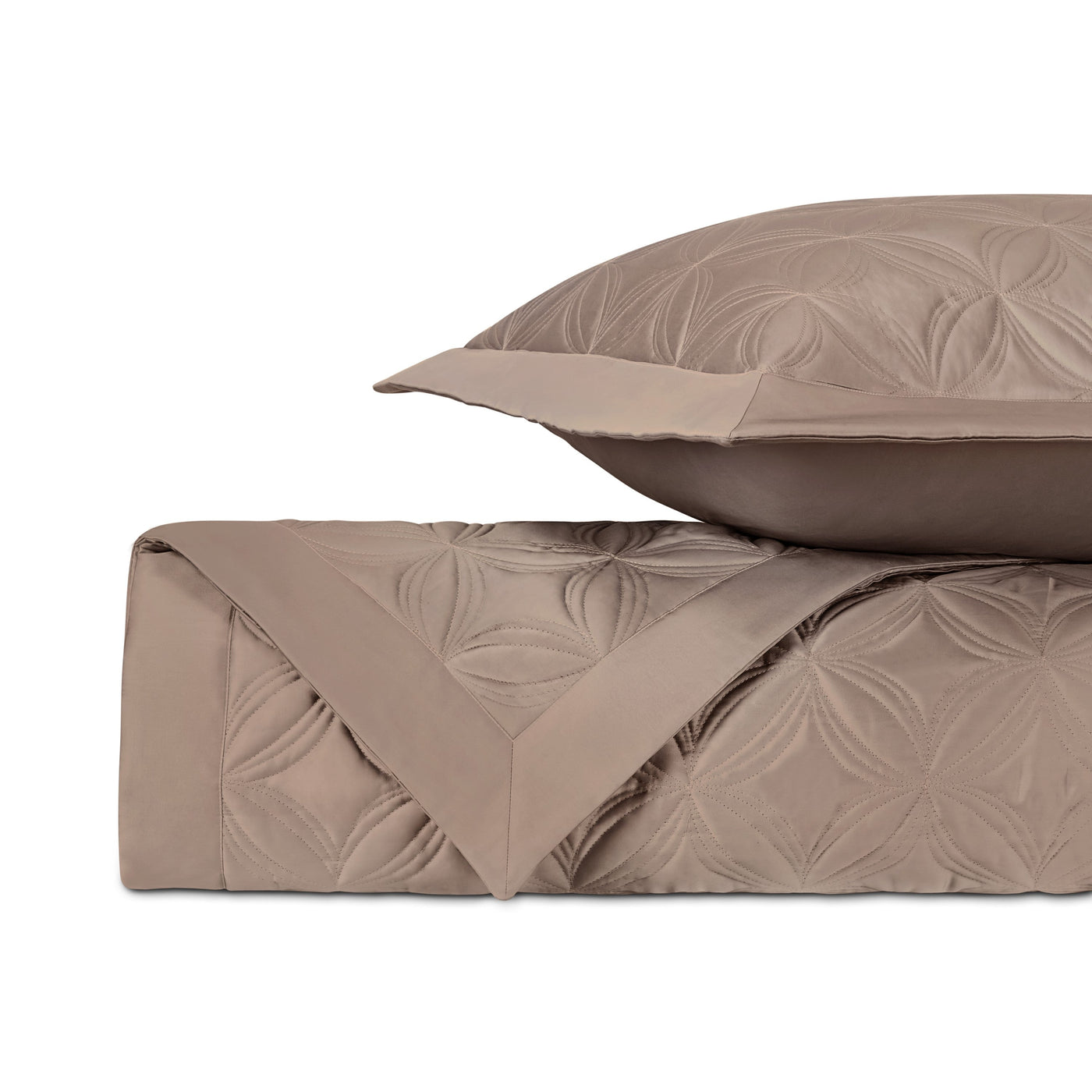 Close-up of taupe quilted coverlet with floral medallion pattern and matching euro sham.