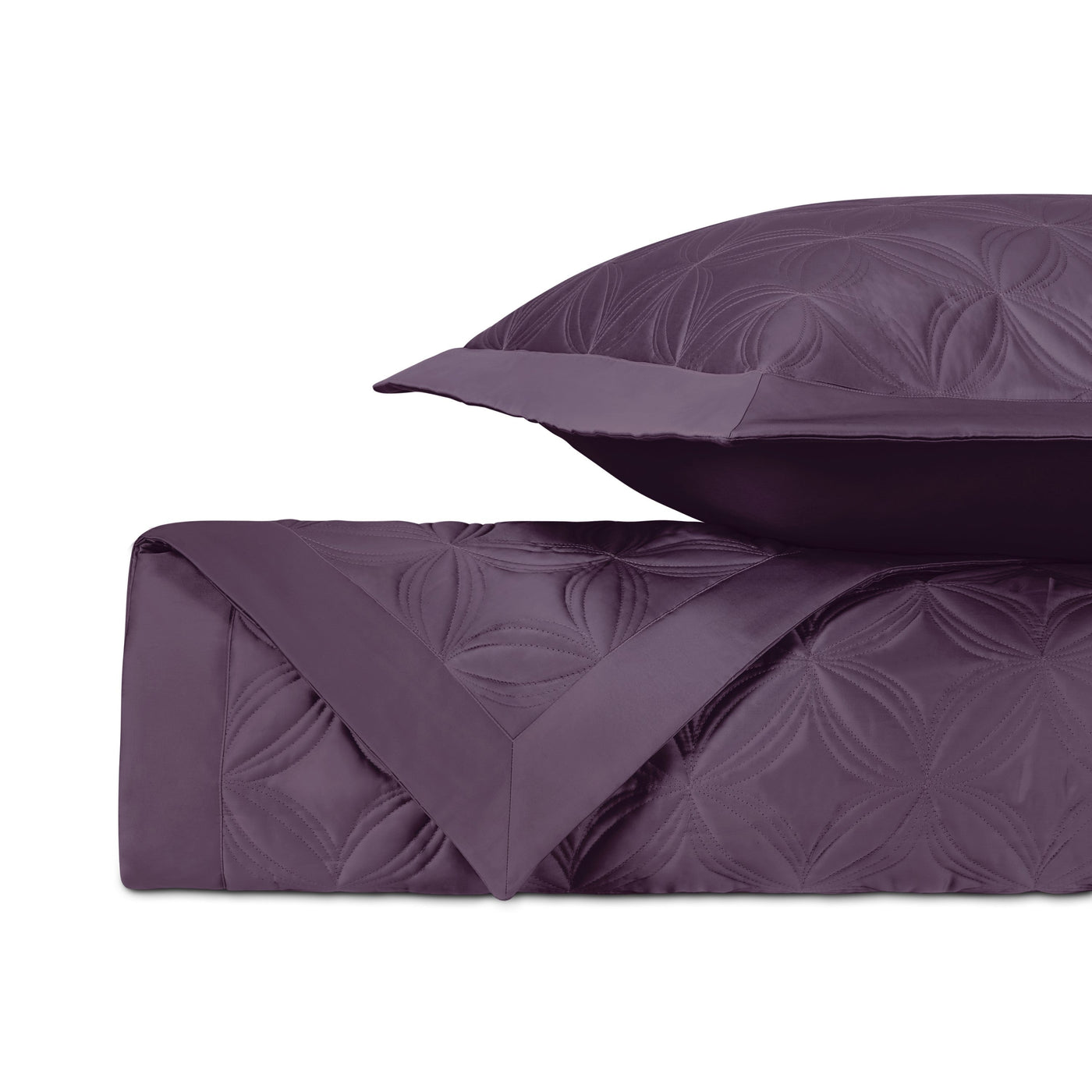 Close-up of Home Treasures Dara quilted coverlet in plum with floral medallion stitching.