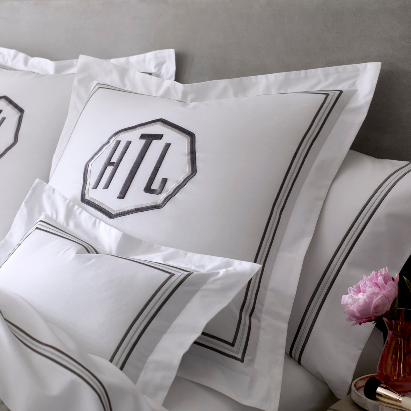 White Home Treasures Delancey pillowcase with charcoal border and monogram embroidery.