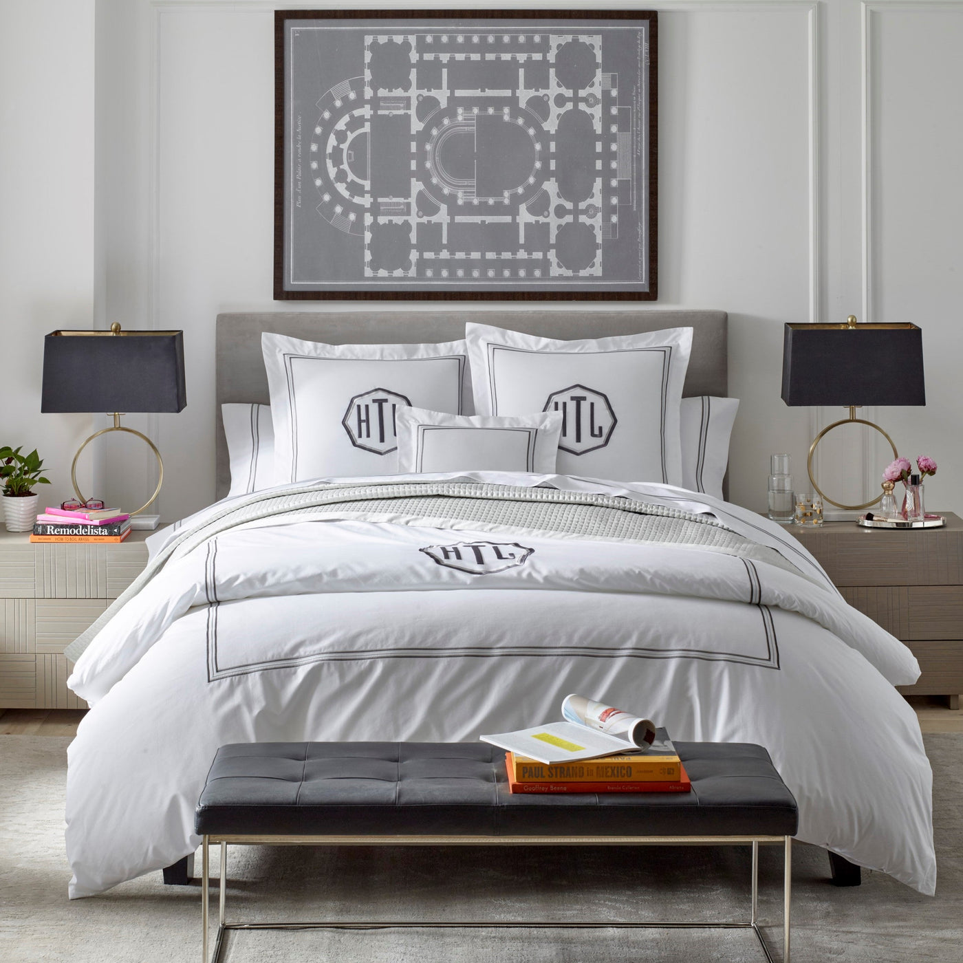 Close-up of Home Treasures Delancey white pillowcase with charcoal border and monogram detail.