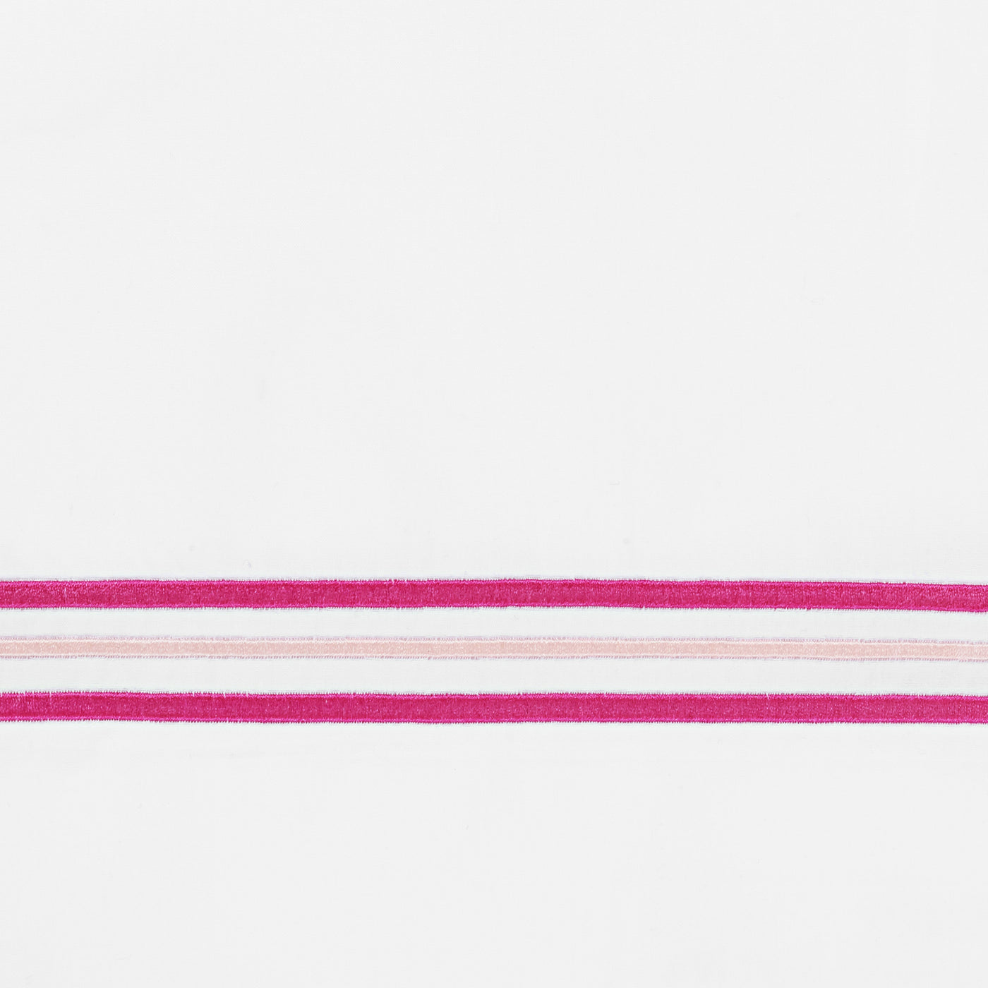 Close-up of fuchsia and blush stripe embroidery detail on white linen fabric.