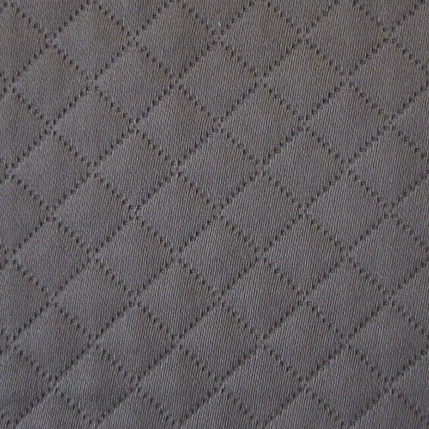 Close-up of slate grey quilted diamond-stitched cotton fabric texture.