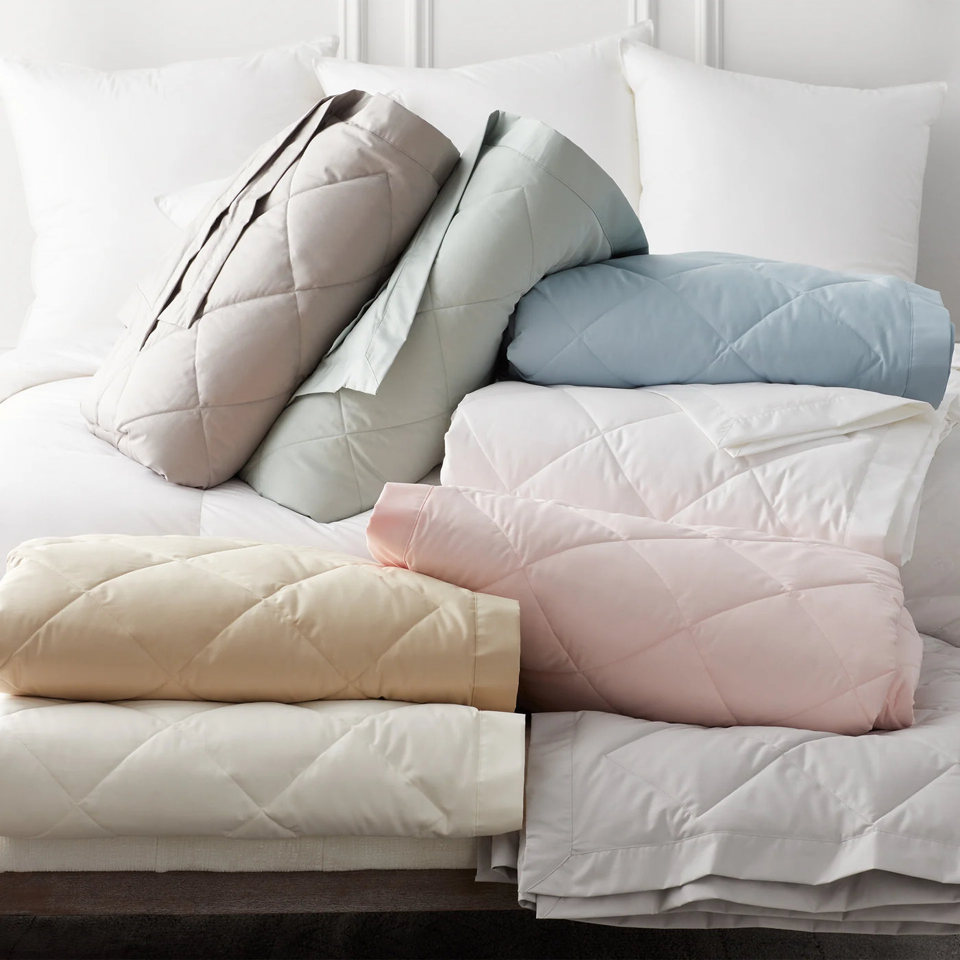 Scandia Home Down Blanket in six colorways: ivory, blush, sky, sage, taupe, and white.