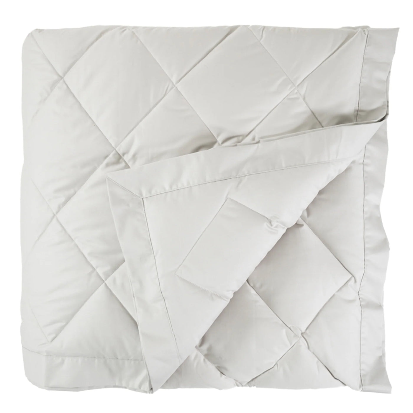Corner fold detail revealing ivory satin binding on a diamond-quilted down blanket.