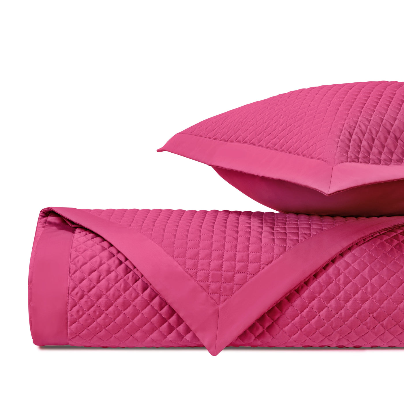 Close-up of Home Treasures Diamond quilted coverlet and sham in fuchsia.