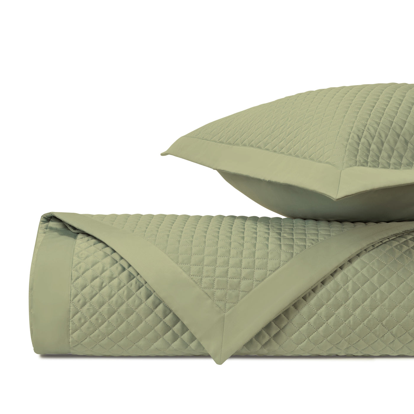 Sage green diamond quilted coverlet and sham set, folded to show texture.