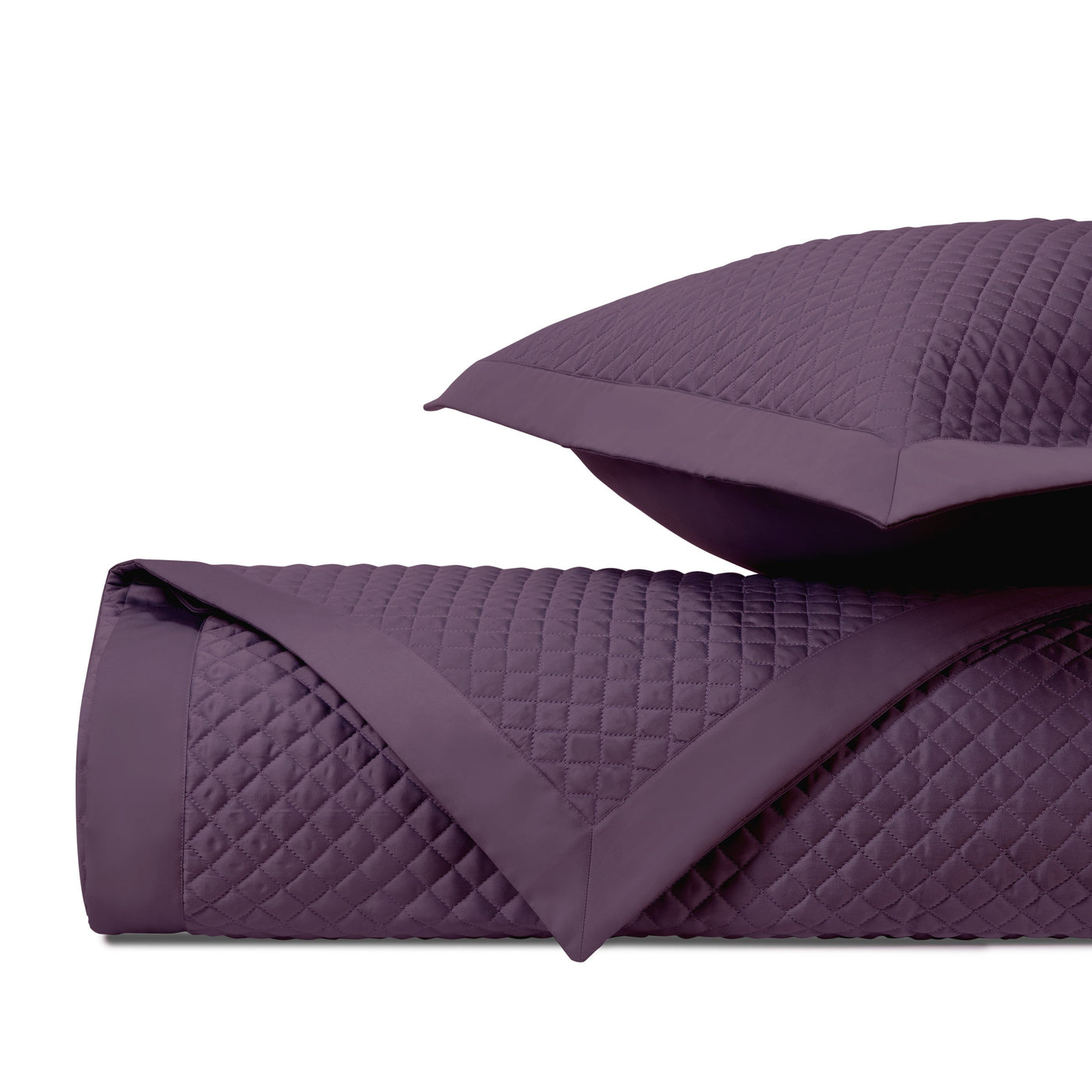 Close-up of Home Treasures Diamond quilted coverlet in deep plum, showing diamond stitching texture.