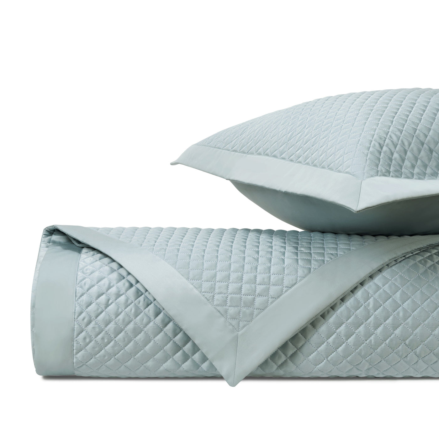 Close-up of mist blue quilted diamond-stitched fabric with sateen border detail.