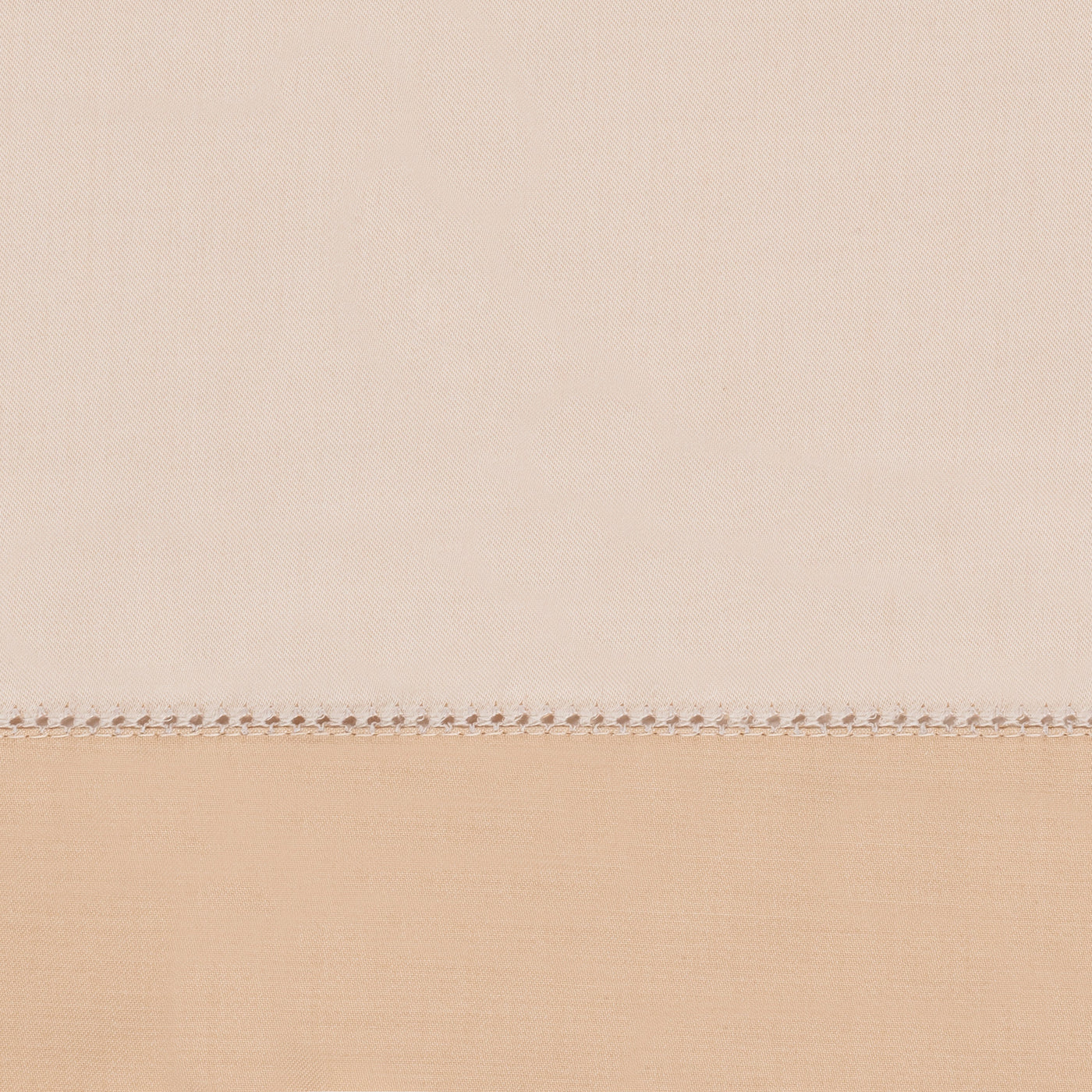 Close-up of ivory and sand cotton fabric panels joined by delicate hemstitch border.