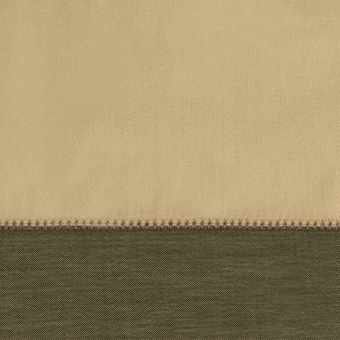Close-up of champagne and olive fabric layers with contrast blanket-stitch edge detail.