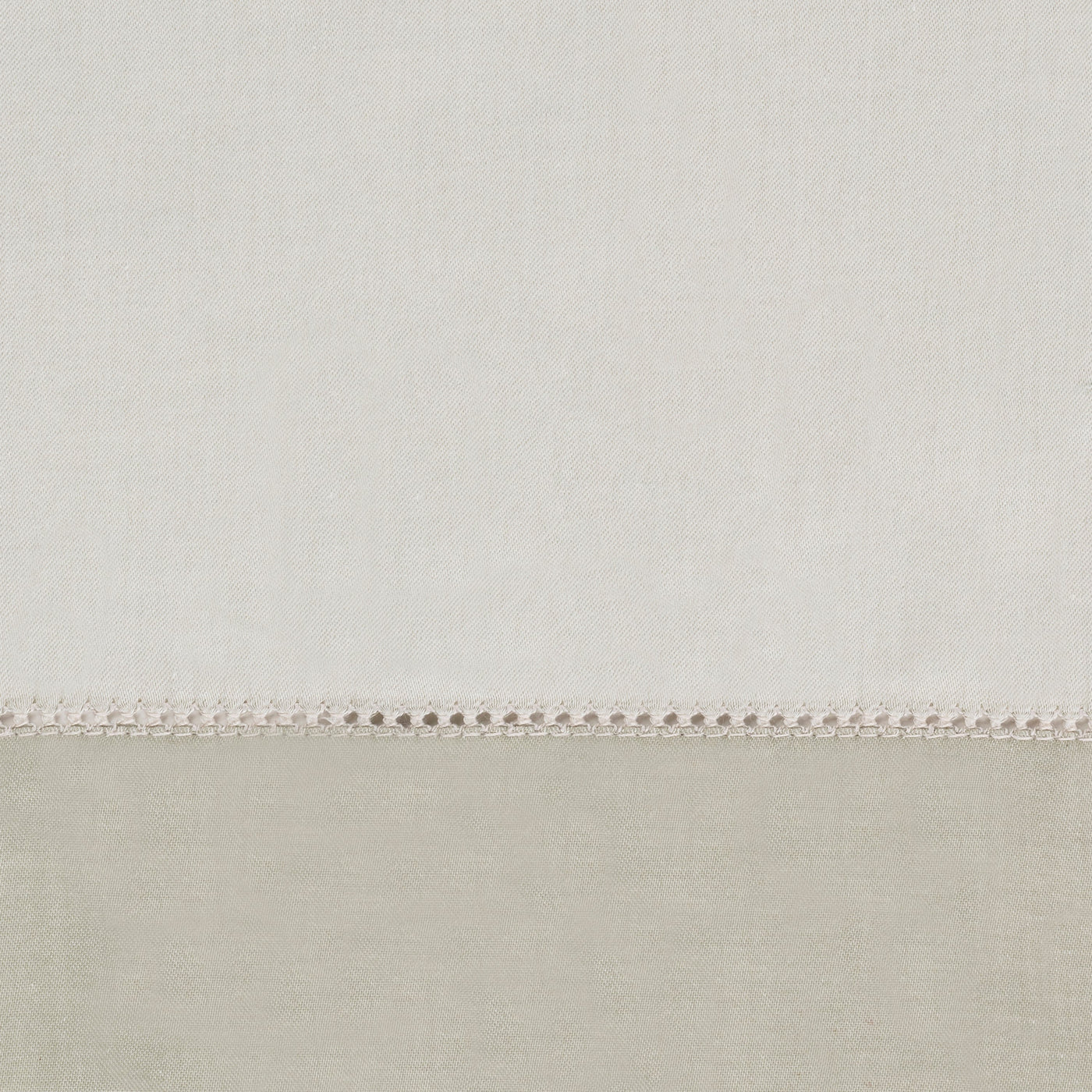 Close-up of ivory linen yardage with delicate hemstitch border detail.
