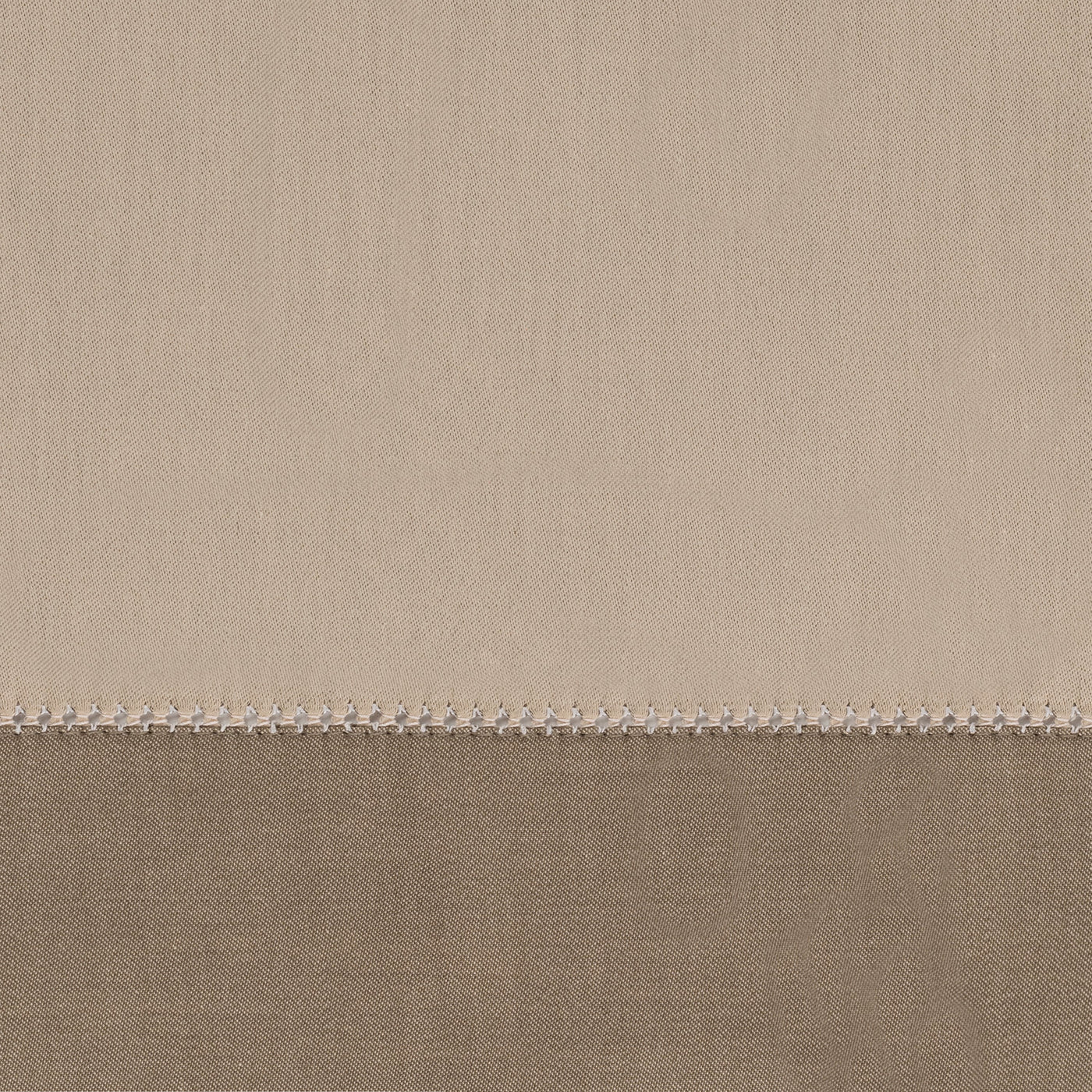 Close-up of taupe and mocha linen yardage with delicate picot edge stitching.