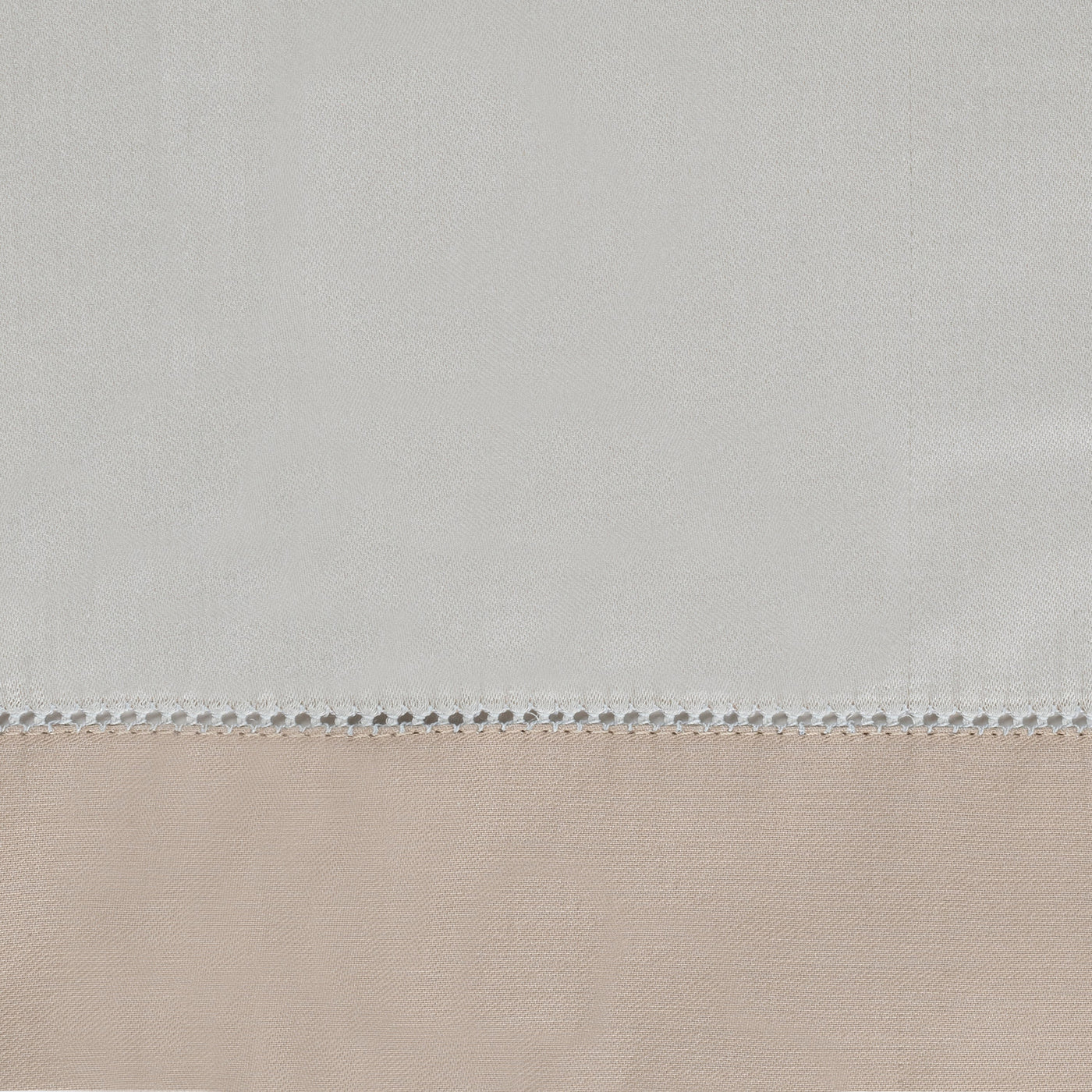 Close-up of ivory and blush linen yardage with delicate ladder-stitch border detail.