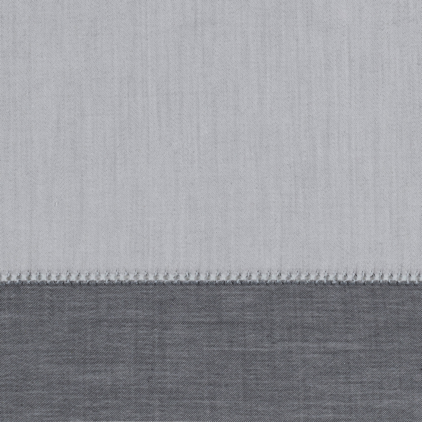 Close-up of silver and charcoal linen yardage with contrast whipstitch border detail.