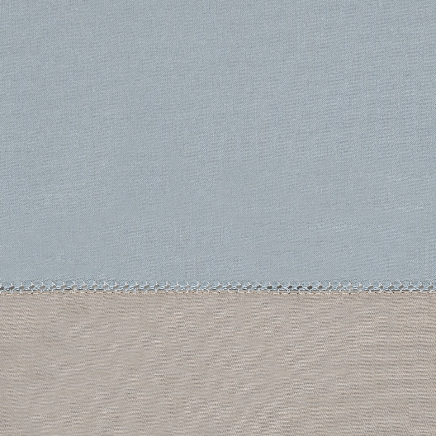 Close-up of sky blue and champagne cotton panels joined by ladder hemstitch trim.