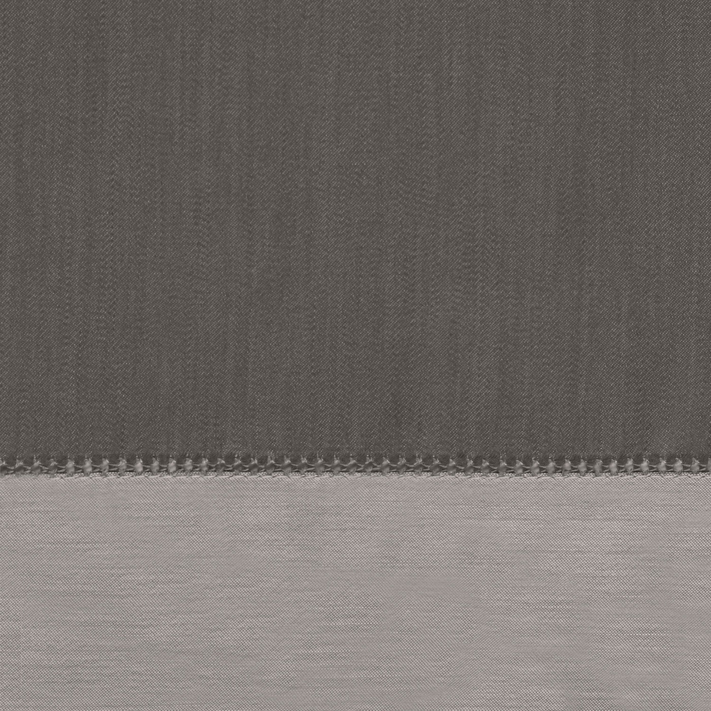 Close-up of charcoal and silver linen yardage with ladder hemstitch border detail.