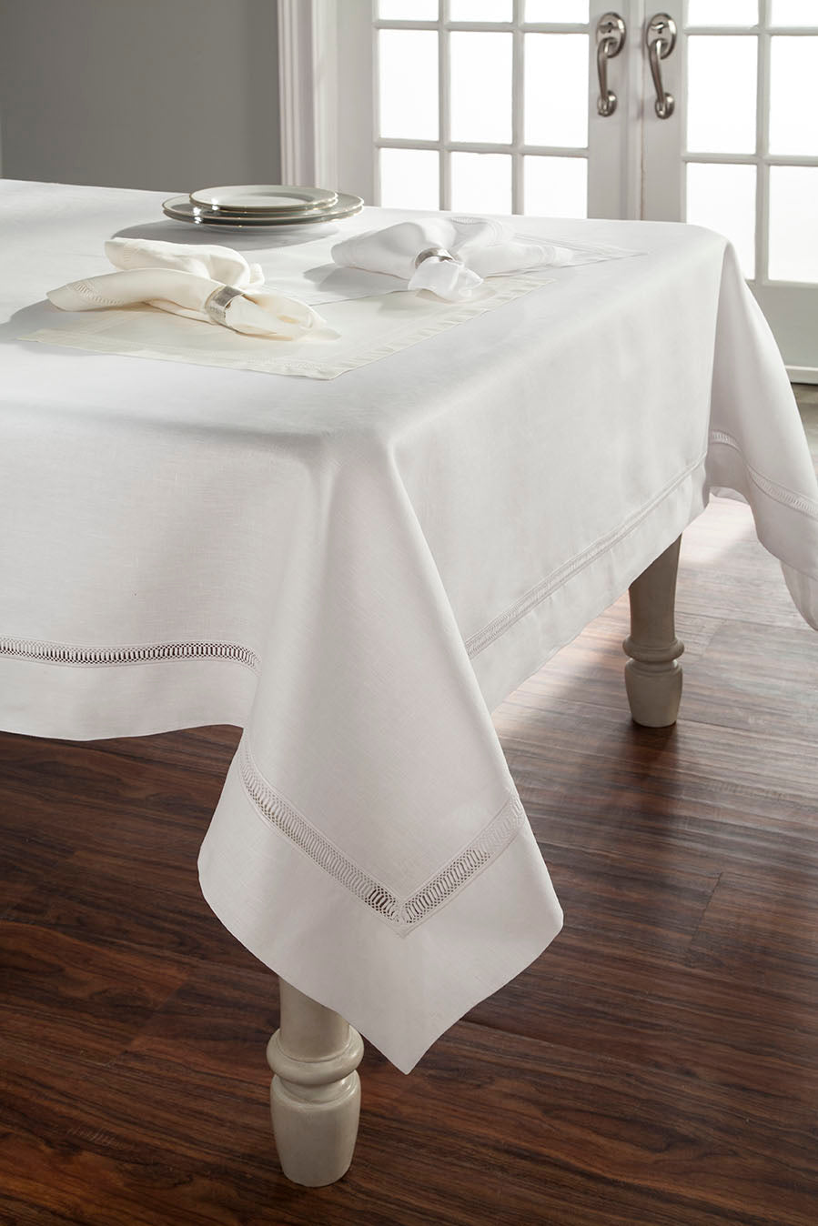 Close-up of Home Treasures Doric hemstitch border detail on white linen tablecloth.