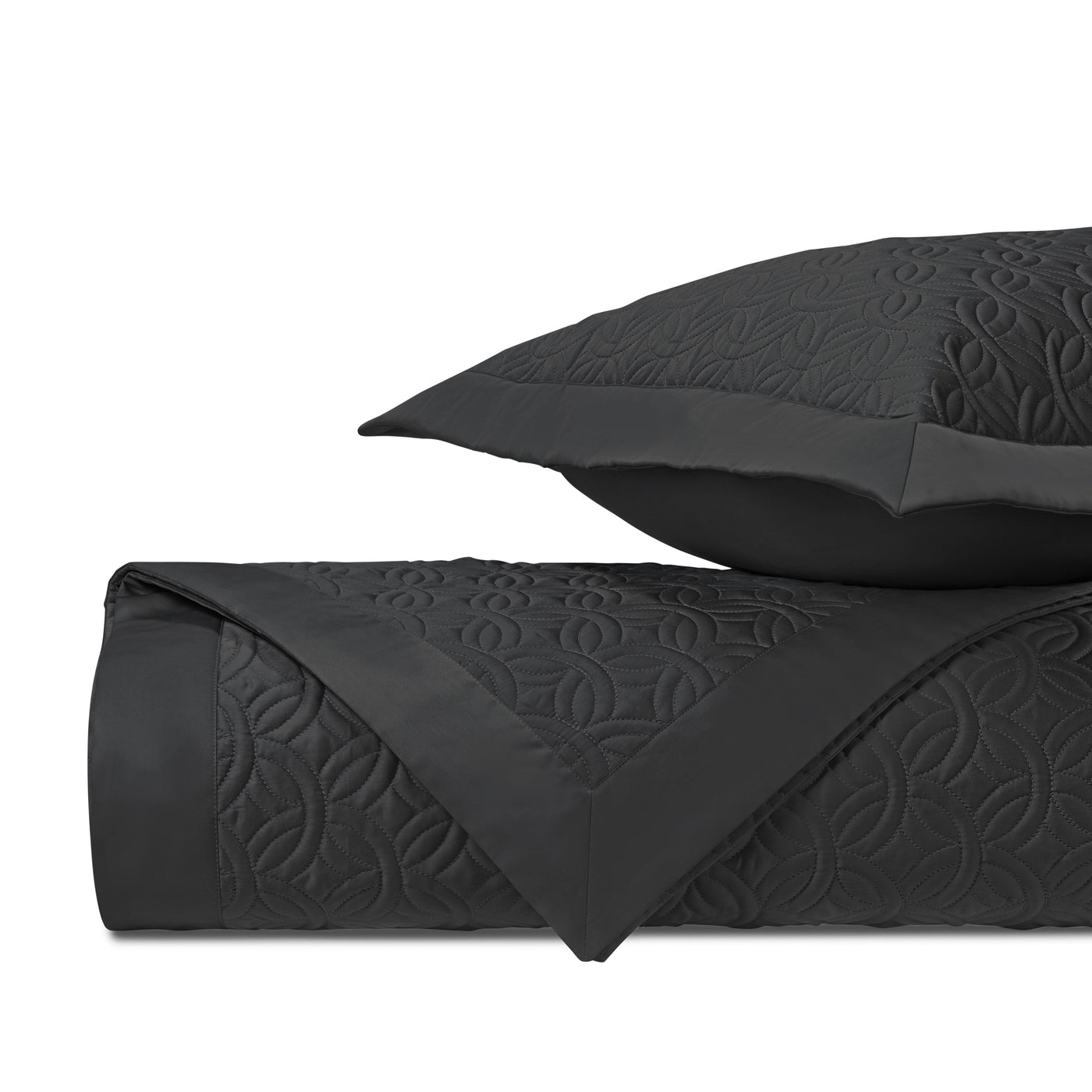 Close-up of Home Treasures Duomo quilted texture in black with floral medallion stitching.