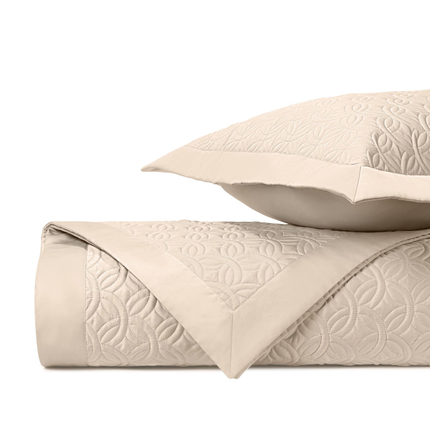 Close-up of Duomo quilted texture in ivory with geometric floral embossed pattern.