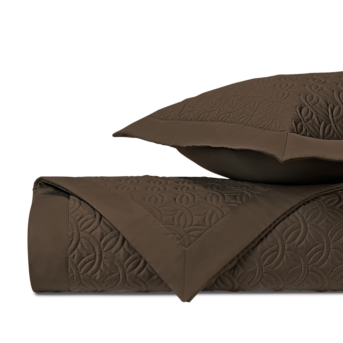 Close-up of Home Treasures Duomo quilted texture in chocolate, showing geometric floral pattern.
