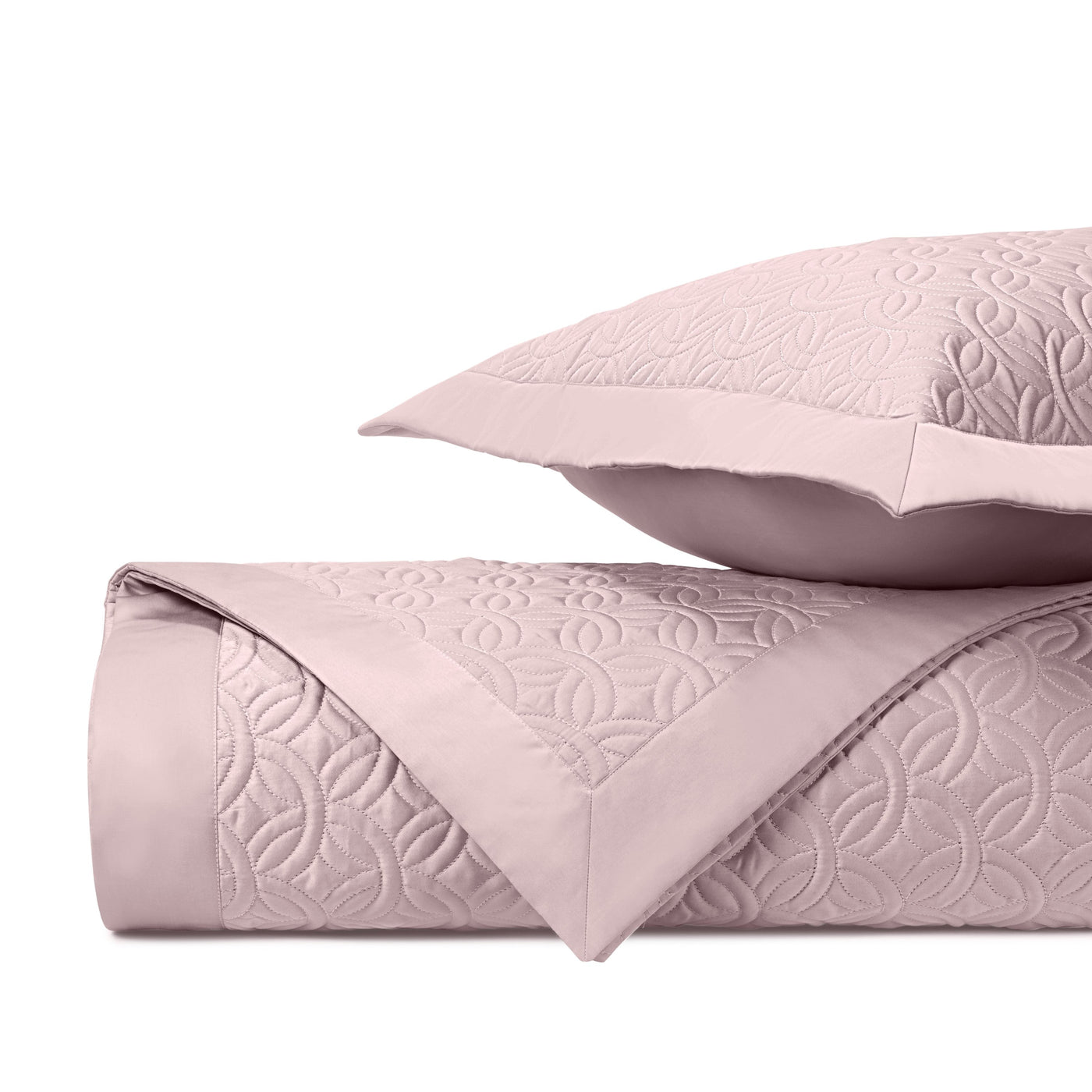 Close-up of Home Treasures Duomo quilted texture in blush with geometric floral pattern.