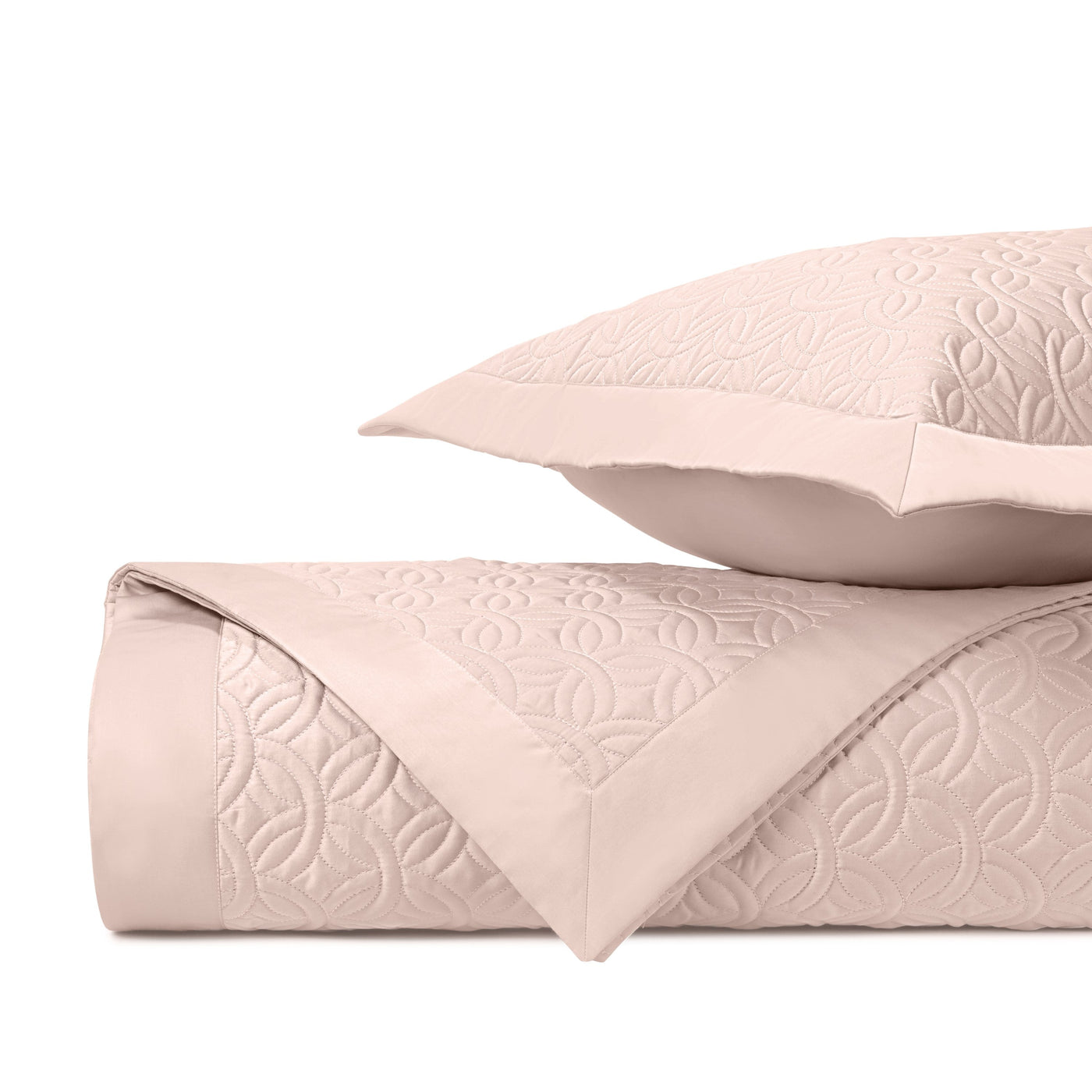 Close-up of Home Treasures Duomo quilted texture in blush with geometric floral motif.