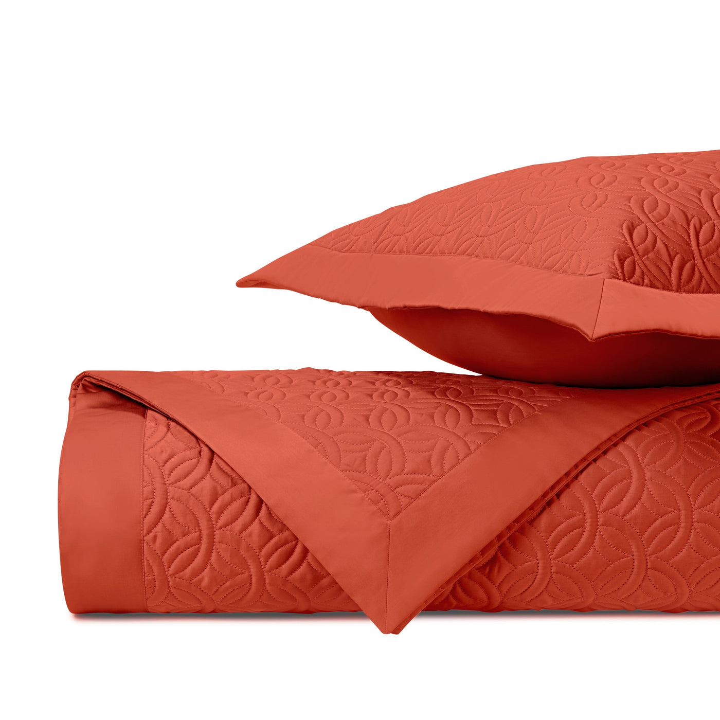 Close-up of Home Treasures Duomo quilted texture in terracotta with geometric floral pattern.