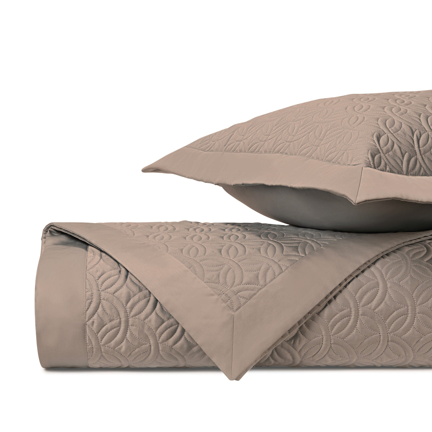 Close-up of Home Treasures Duomo quilted texture in taupe with geometric floral stitching.