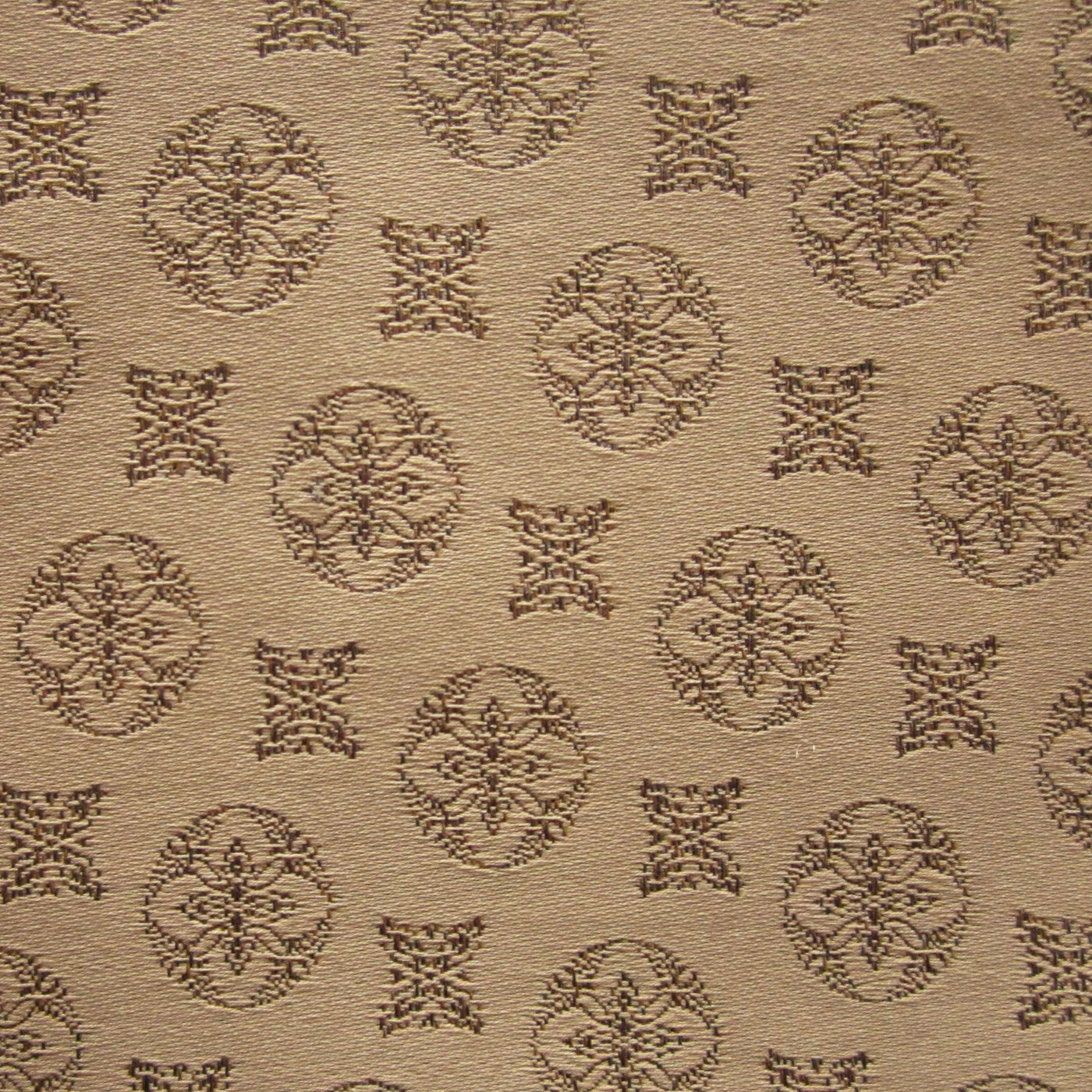 Close-up of Duomo fabric weave with tonal caramel medallion jacquard pattern.