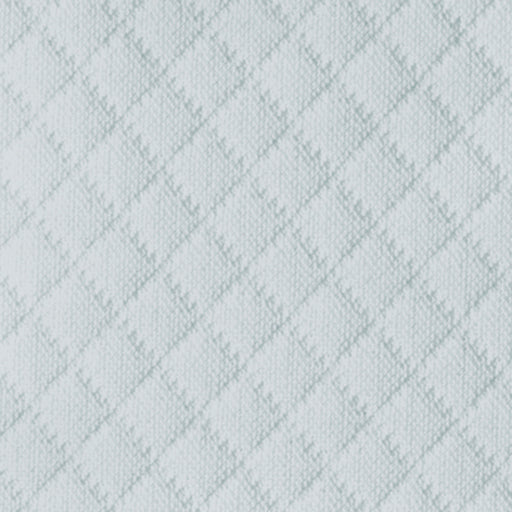 Close-up of Matouk Elliot coverlet showing diamond quilted texture in pale mist.