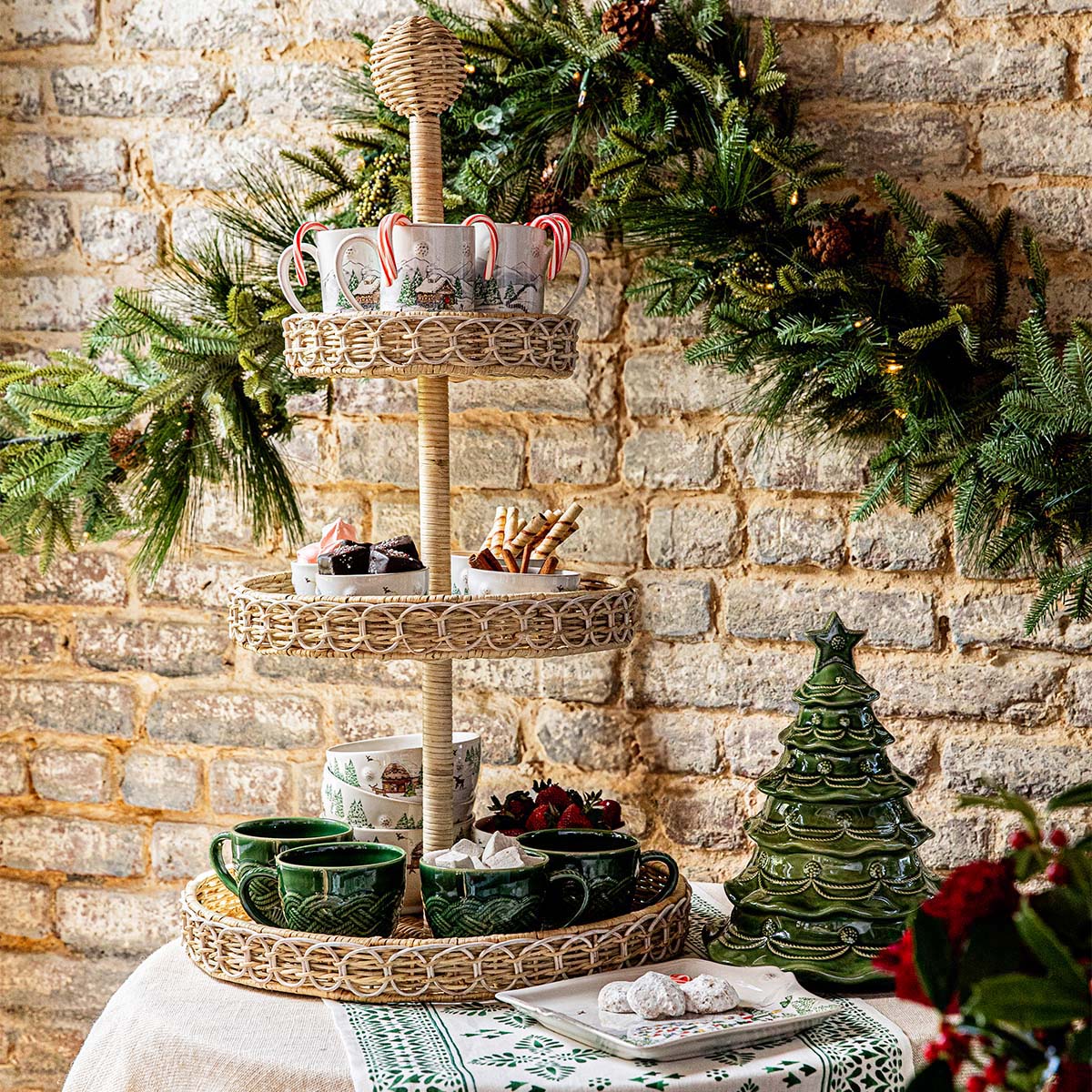 Basil Christmas tree cookie jar beside a tiered server under holiday garland