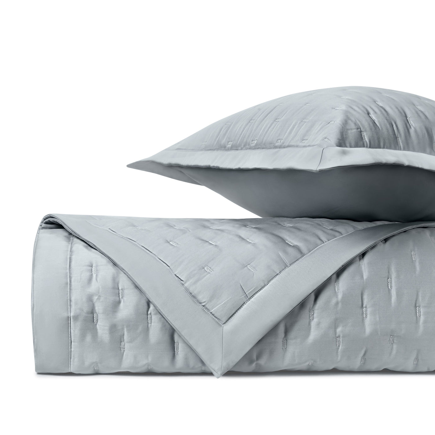Close-up of Home Treasures Fil Coupé quilted texture in pale silver-blue with contrast border.