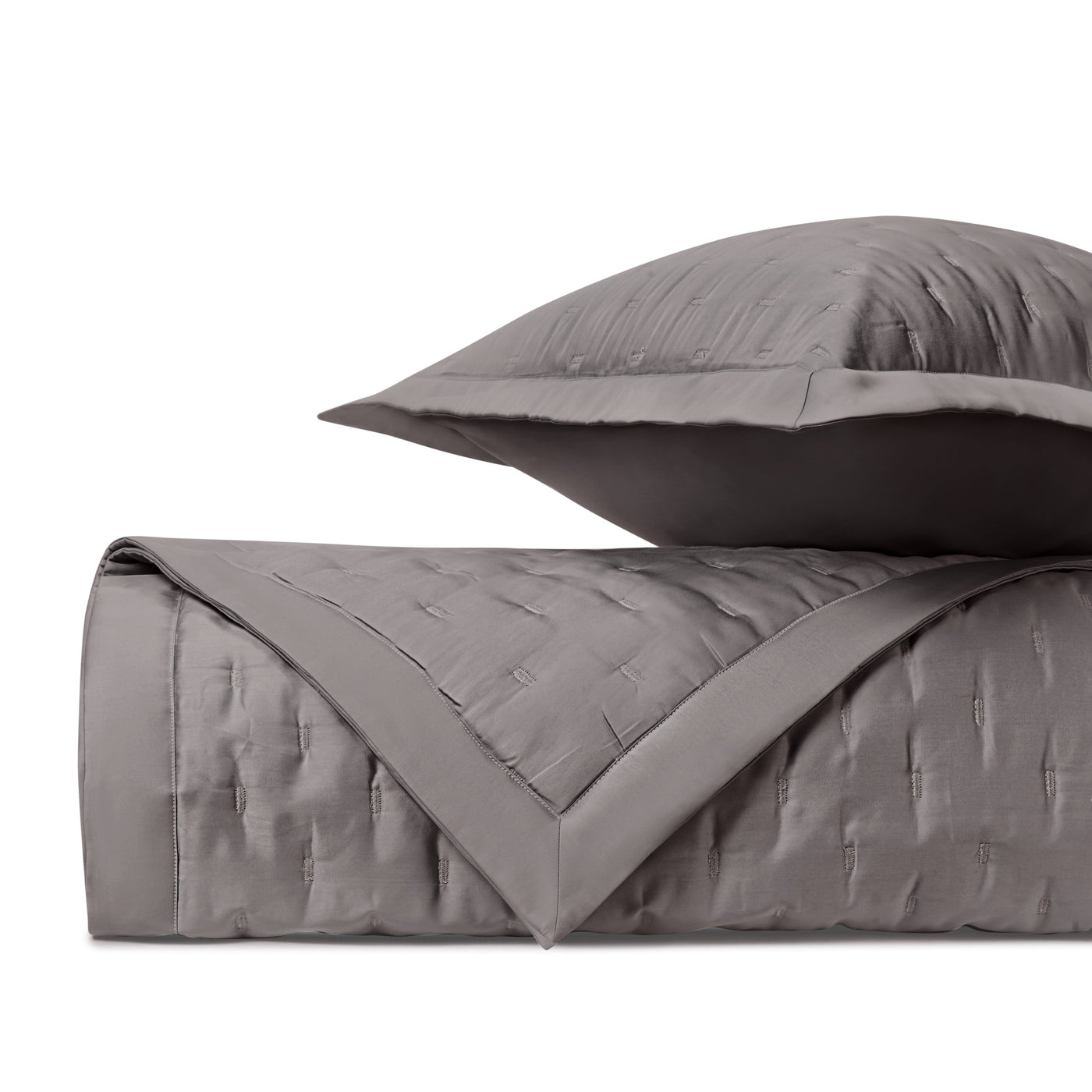 Charcoal quilted satin close-up showing geometric fil coupé texture and border detail.