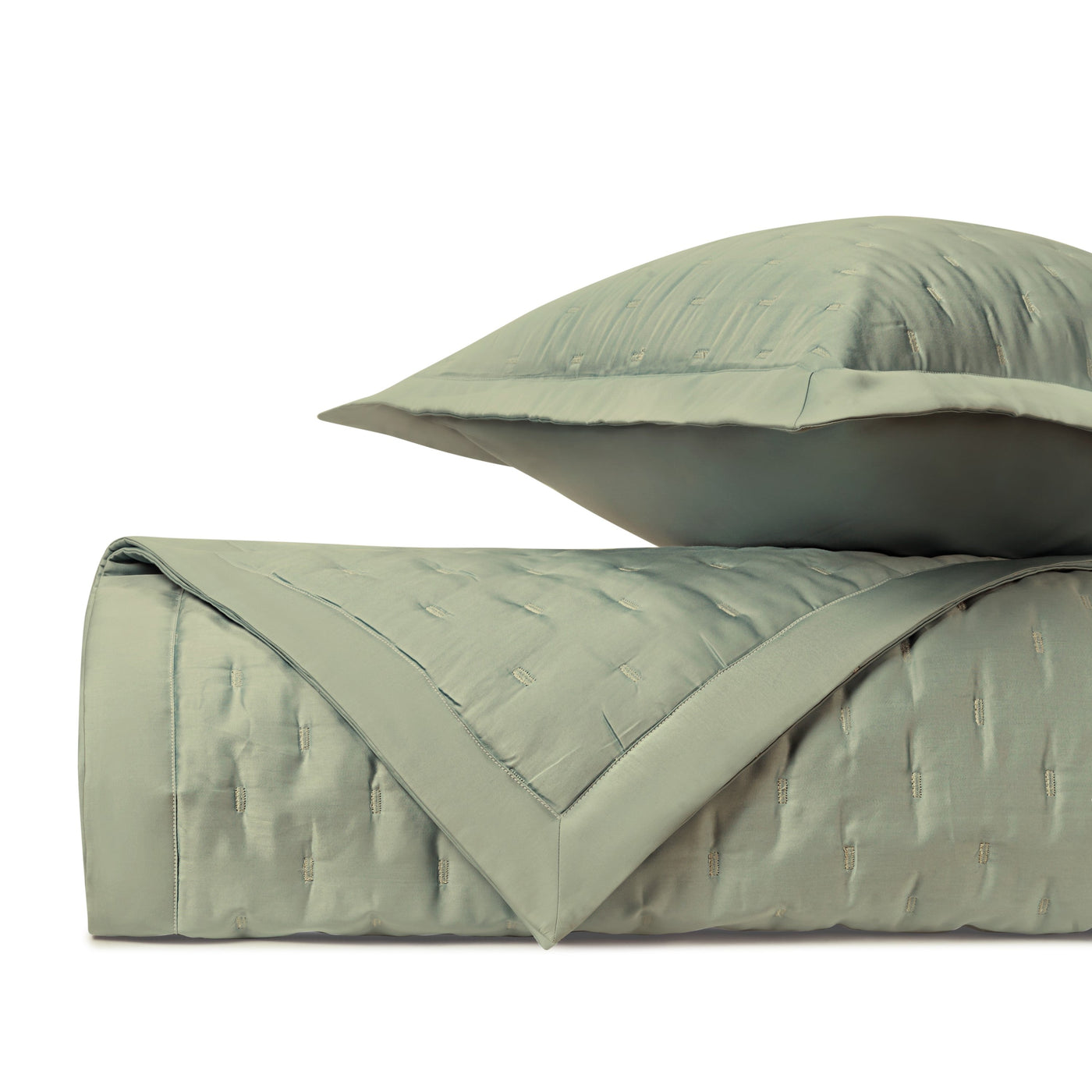 Close-up of Home Treasures Fil Coupé quilted texture in sage green with contrast border detail.