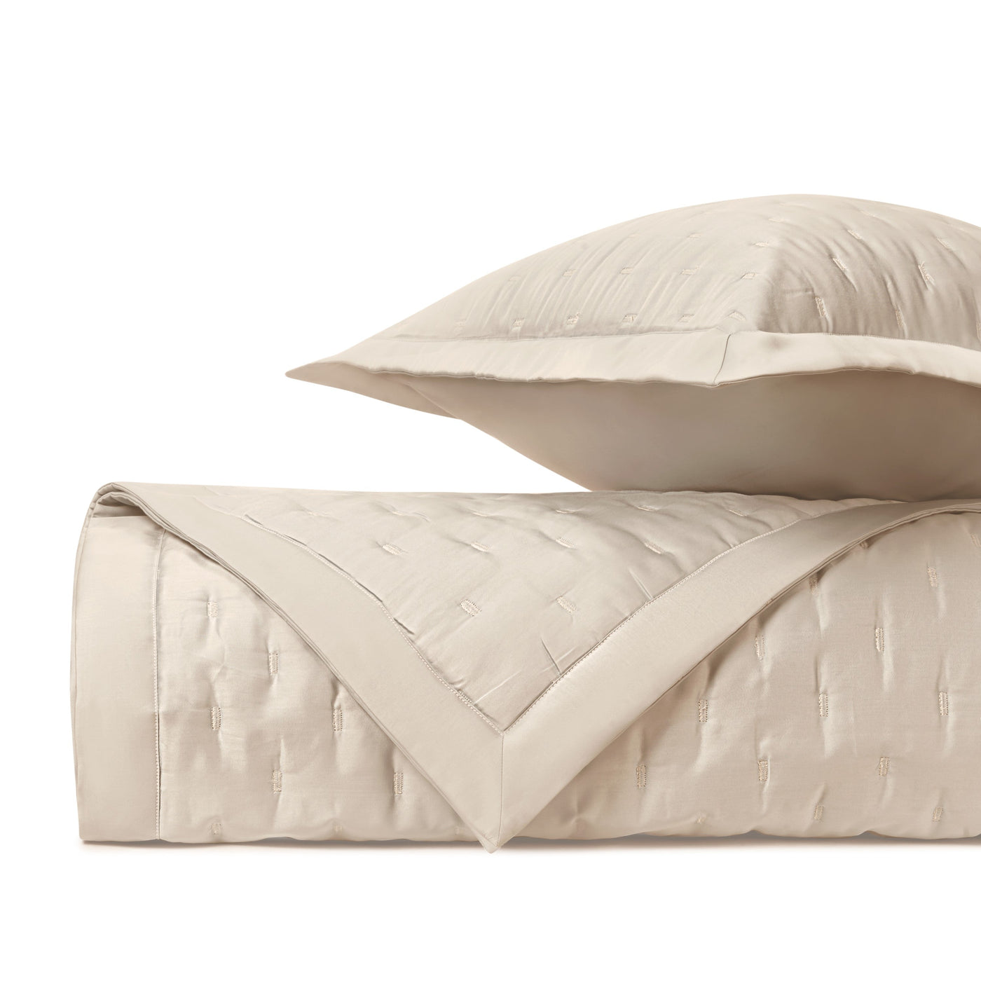 Close-up of ivory quilted fil coupé texture with contrast border detailing.