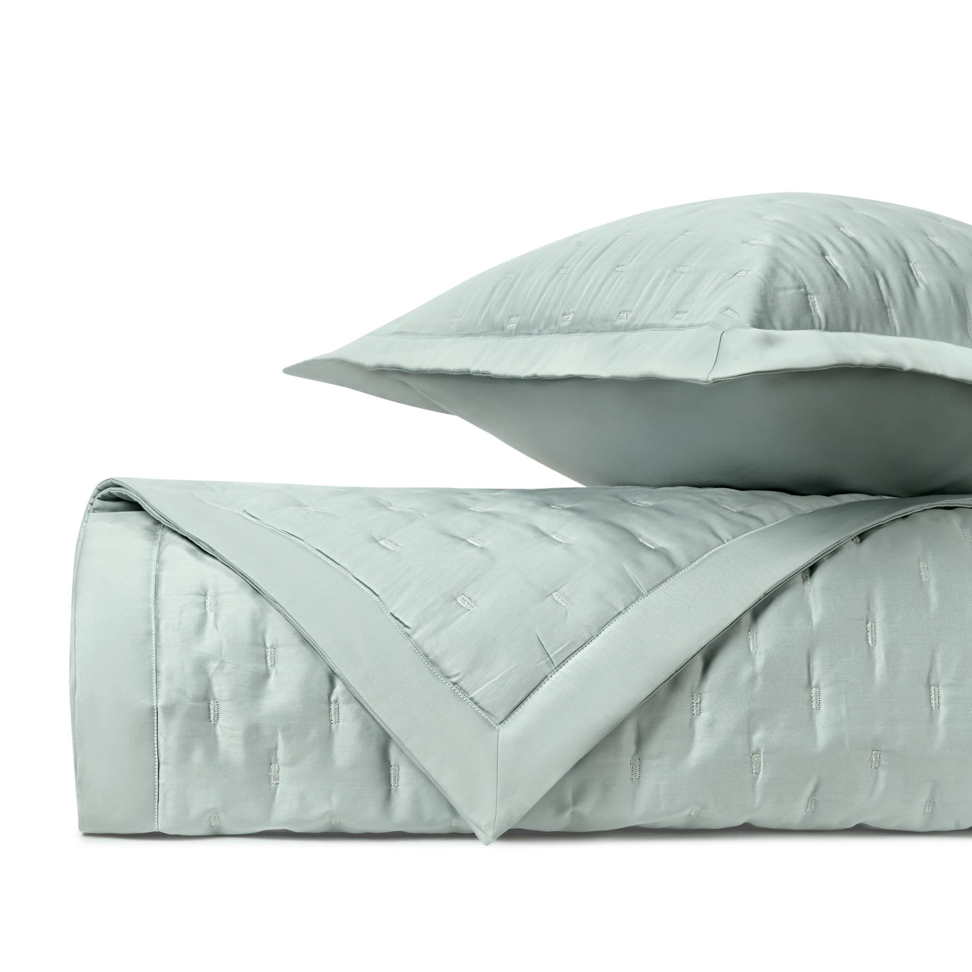 Closeup of mist blue fil coupé quilted texture with contrast border detail.