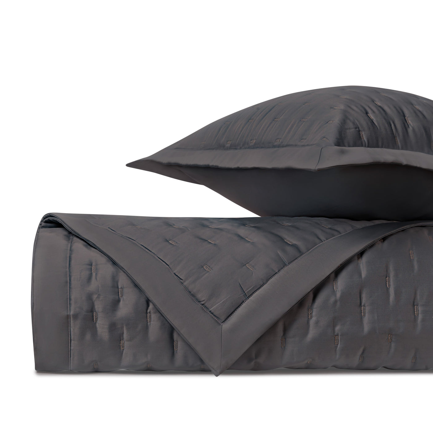 Close-up of Home Treasures Fil Coupé quilted coverlet and pillow sham in charcoal.