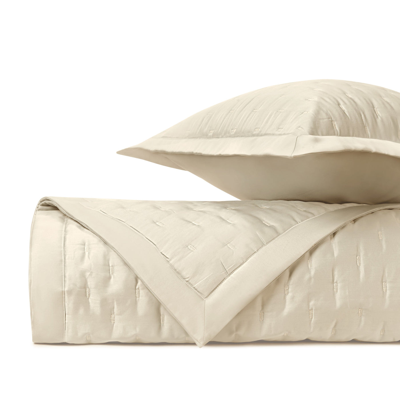 Close-up of Home Treasures Fil Coupé quilted texture in ivory with a satin border trim.