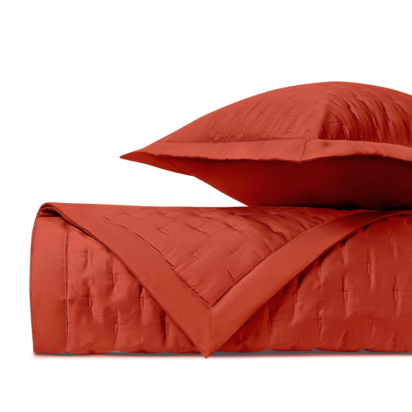 Close-up of Home Treasures Fil Coupé quilted texture in tomato red with matching sham.