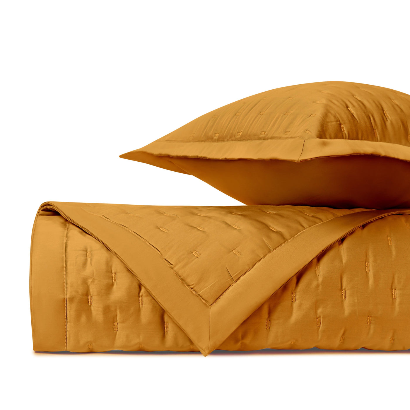 Close-up of Home Treasures Fil Coupé quilted texture in marigold, folded with matching sham.