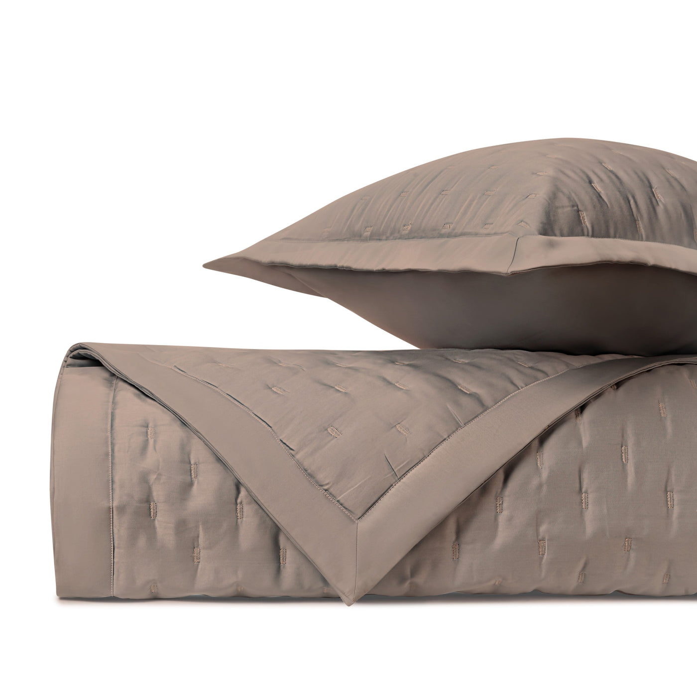Close-up of Home Treasures Fil Coupé quilted coverlet in taupe with textured woven pattern.