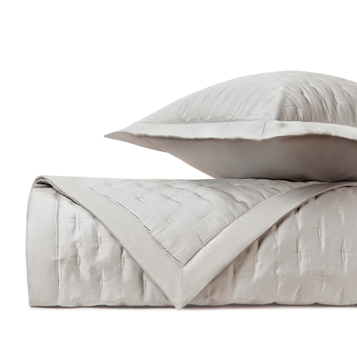 Close-up of Home Treasures Fil Coupé quilted texture in pearl with satin border detail.
