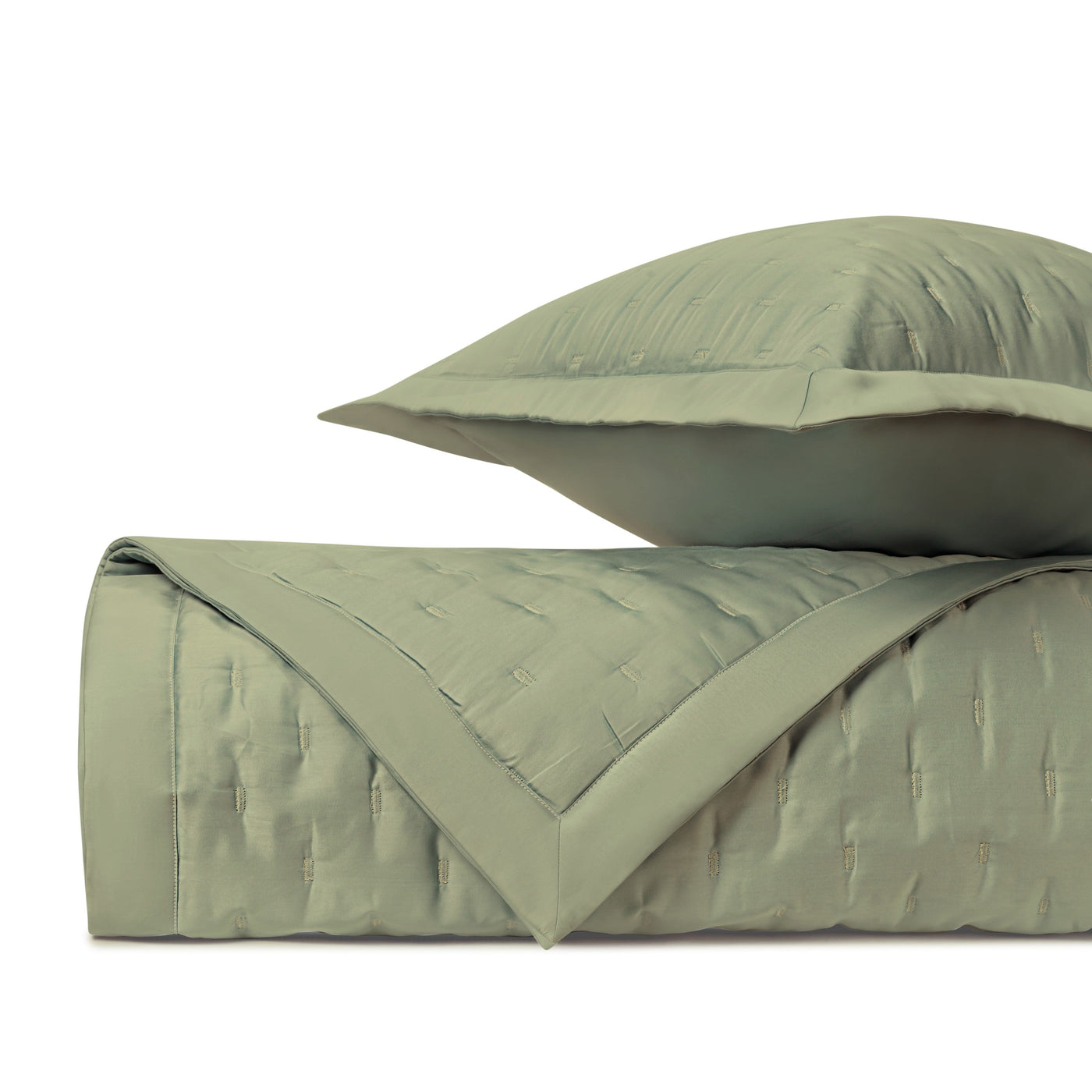 Close-up of Home Treasures Fil Coupé quilted texture in sage green with contrast border.